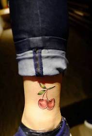 a string of cherry tattoo tattoos falling on the calf