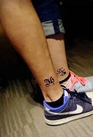 sports couple small totem tattoo picture on bare feet