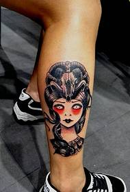 a beautiful woman tattooed on a small leg