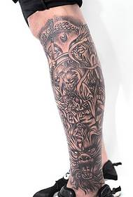 seemingly complicated black and white totem tattoo on the calf