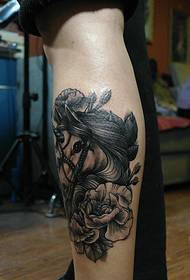 black and white flowers and horses combined with the leg tattoo picture