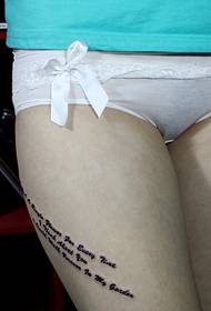 girl thighs letter tattoo