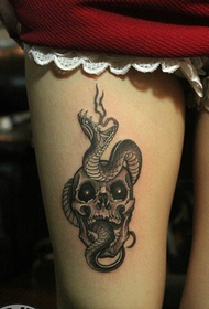 python tattoo on female thigh