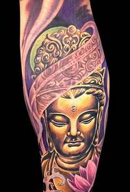 a golden Buddha tattoo on the leg