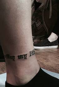 a small body English word tattoo in the calf