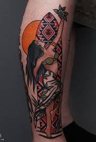 Painted tribal woman tattoo pattern on calf
