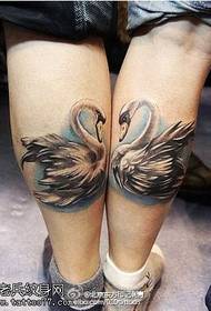 Two swan tattoo designs on the calf
