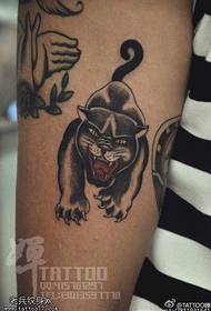 Ferocious cat tattoo on the thigh