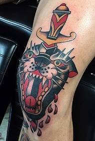 Tattooed tiger head tattoo on the knee