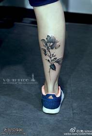 Ink floral tattoo pattern on calf