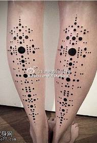 Black dot tattoo pattern on the legs
