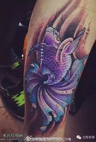 Purple goldfish tattoo pattern on calf
