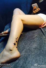 Beautiful little five-pointed star tattoo on the legs