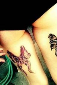 Beautiful and beautiful bow tattoo on the legs