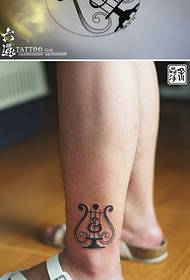 Small harp mini tattoo pattern on the legs
