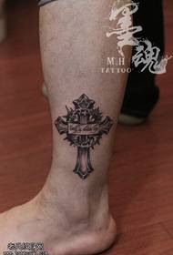 Nohy s atramentovým krížovým tetovaním