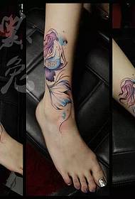 The colorful mermaid tattoos in the legs are shared by the tattoo show.