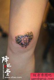 A popular and beautiful love lock tattoo on the leg