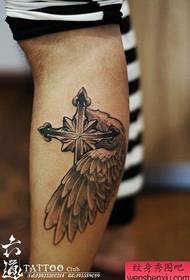 a cross-winged tattoo pattern popular in the leg