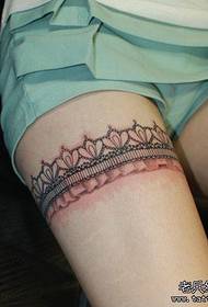 a woman's leg lace tattoo pattern