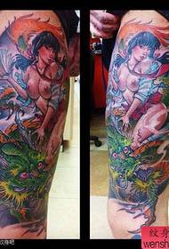 Male legs with a beautiful beauty and dragon tattoo pattern