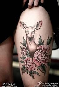 Woman legs colored fawn rose tattoo picture