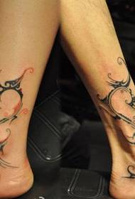 Beautiful and stylish couple totem tattoo pattern on the legs