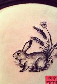 Woman's leg pricking rabbit tattoo work