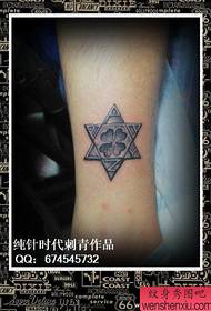 Small and beautiful six-pointed star tattoo on the legs