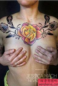 A beautiful pop rose tattoo on a beautiful woman's chest