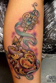 a heart lock and key tattoo on the leg