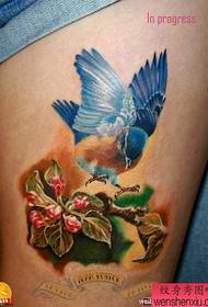 E bukur dhe e bukur model i tatuazheve me zogj me ngjyra për këmbët e vajzave