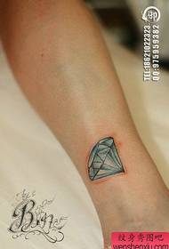 Small, classic, colorful diamond tattoo pattern on the legs