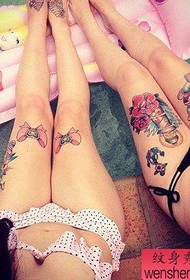 Woman legs colored tattoos