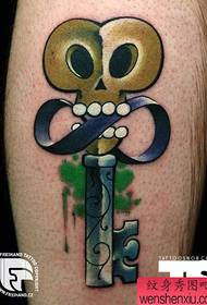 a creative key tattoo on the leg