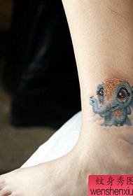 Woman legs colored elephant tattoos