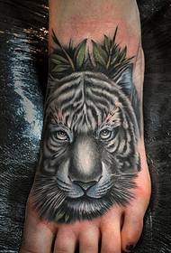a picture of a domineering tiger tattoo on a beautiful instep