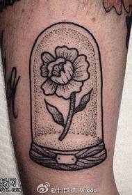 small flower tattoo on the ankle