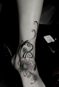 female instep and flower vine tattoo
