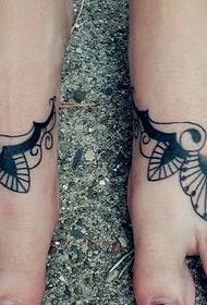 beautiful totem tattoo on female feet