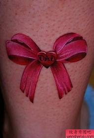 Beautiful girl's legs are popular with a bow tattoo pattern