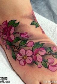 delicate peach flower tattoo pattern on the foot