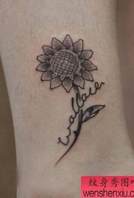 a nice sunflower flower tattoo pattern on the girl's leg