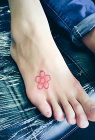 a small cherry tattoo tattoo on the instep