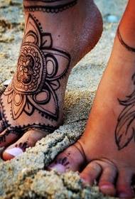 female matching feet on the same matching tattoo pattern