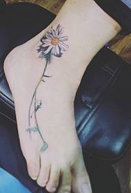 small daisy tattoo on the girl's foot