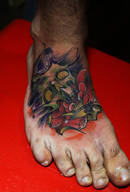 Instep flower and skull tattoo