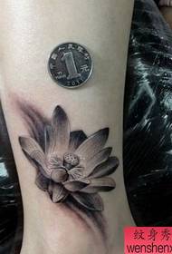 a beautiful black gray lotus tattoo pattern for girls legs