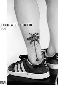 a coconut tree tattoo on the ankle