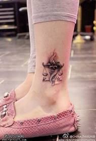 woman's ankle Libra tattoo figure